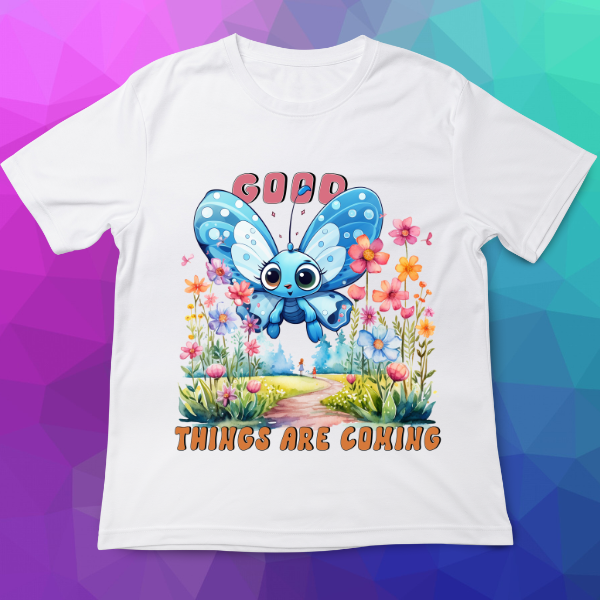 White t-shirt with a blue butterfly graphic and 'Good Things Are Coming' text on a colorful geometric background
