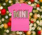 Pink t-shirt with Christmas-themed design on a blurred festive background