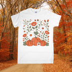 White t-shirt with pumpkins and floral design in an autumn forest setting