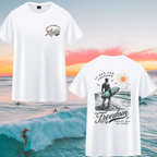 White t-shirt with a surfer design and 'Freedom' text against a beach sunset background