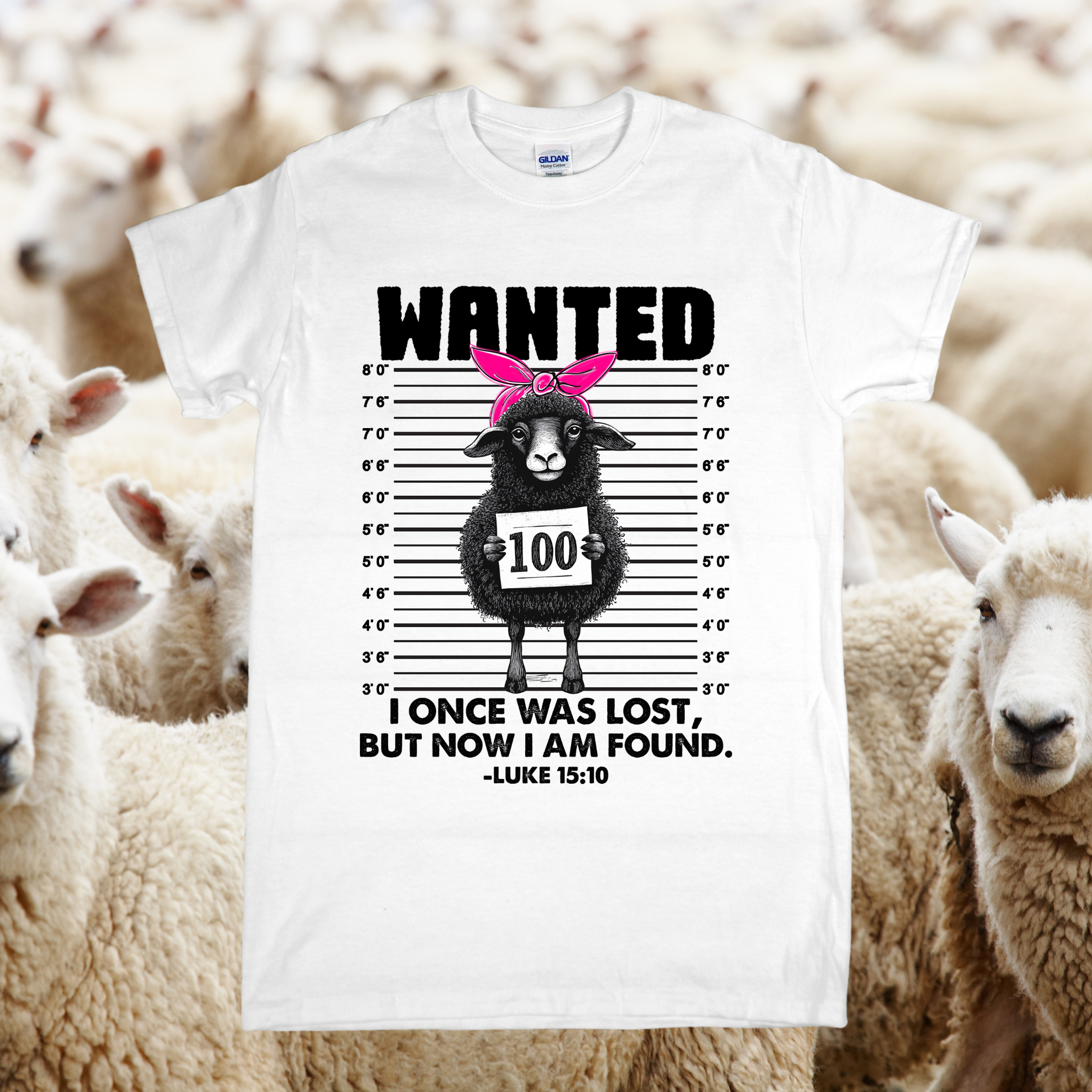 White t-shirt with a graphic of a sheep in a 'wanted' poster style design, surrounded by sheep.