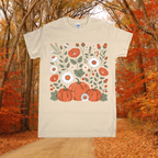 Beige t-shirt with pumpkins and floral design in an autumn forest setting