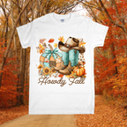 White t-shirt with autumn-themed design featuring boots, pumpkins, and 'Howdy Fall' text, set against a forest background.