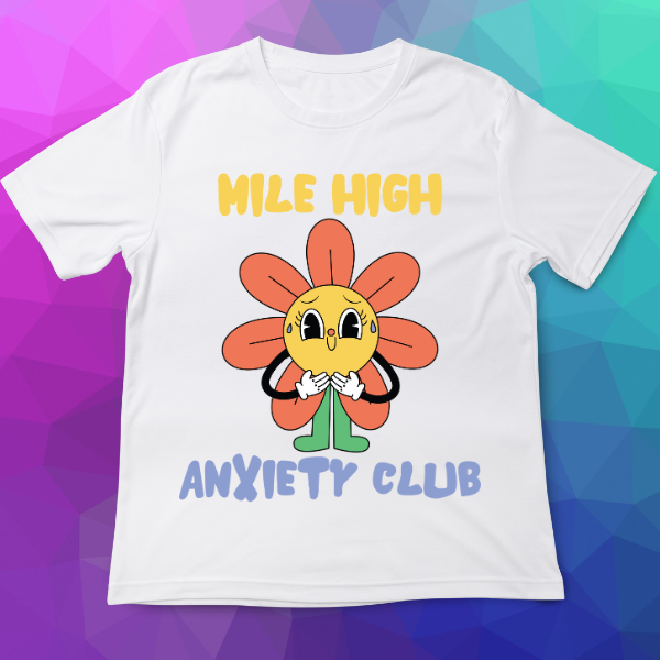 White t-shirt with a cartoon flower design and text on a colorful geometric background