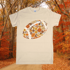 Beige t-shirt with floral football design against a forest background