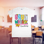 White t-shirt with colorful text 'BRUH WE BACK teachers' in a classroom setting