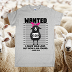 Gray t-shirt with a graphic of a sheep on a wanted poster, surrounded by sheep in a field.