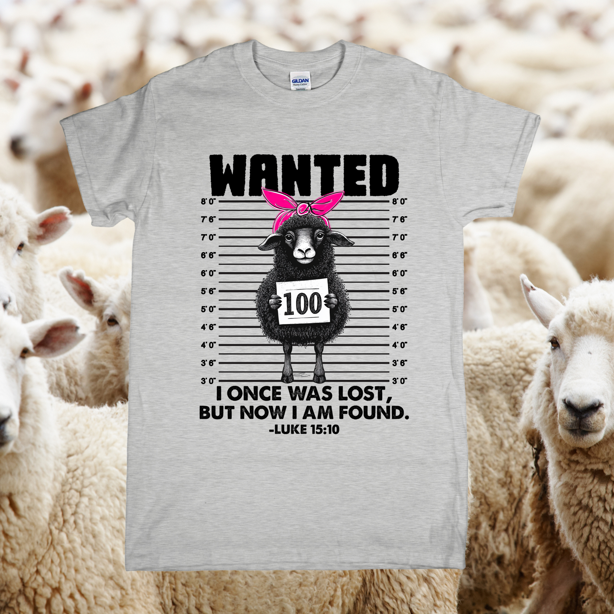Gray t-shirt with a graphic of a sheep on a wanted poster, surrounded by sheep in a field.