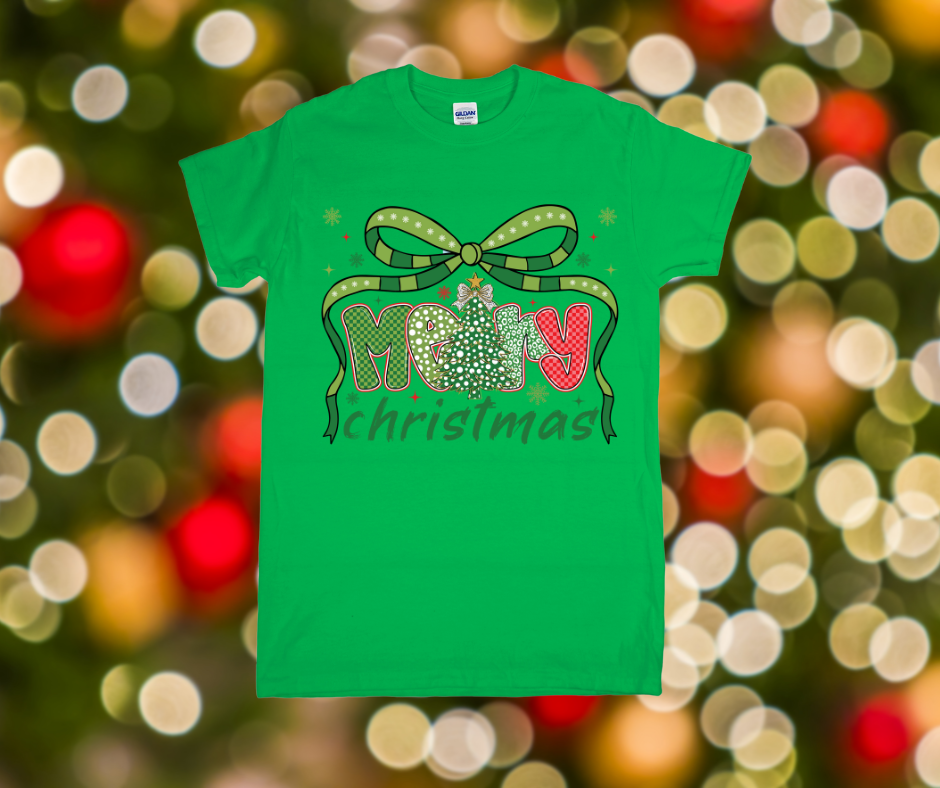 Green t-shirt with Christmas design on a blurred festive lights background