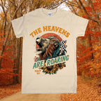 T-shirt with a lion graphic and text 'The Heavens Are Roaring' in an autumn setting