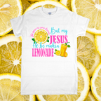 White t-shirt with colorful text and graphics on a background of lemon slices