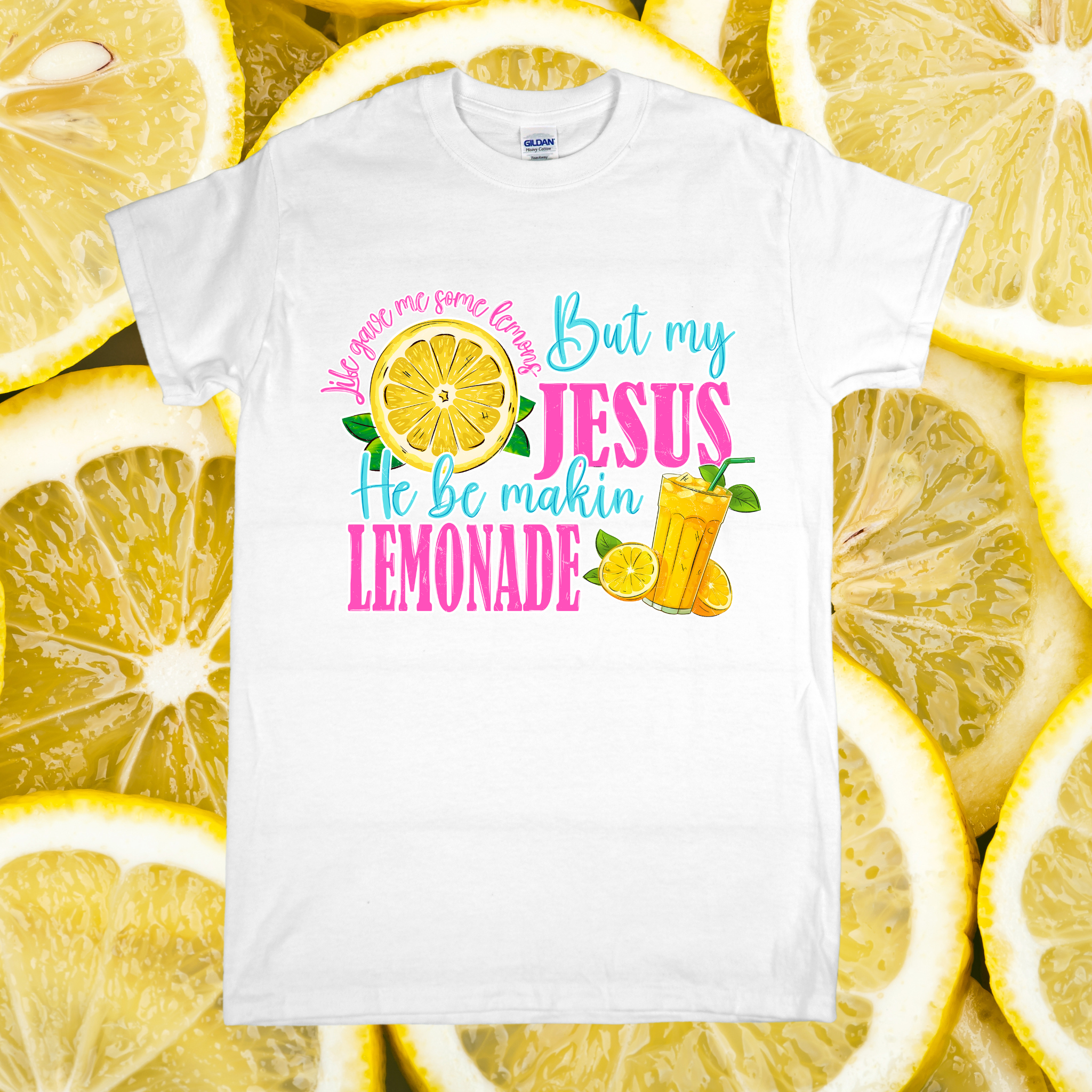White t-shirt with colorful text and graphics on a background of lemon slices