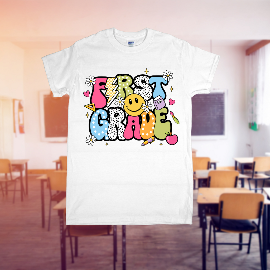 White t-shirt with 'First Grade' design in a classroom setting