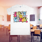 White t-shirt with 'First Grade' design in a classroom setting