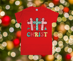 Red t-shirt with Christmas-themed design featuring crosses and 'Christ' text against a festive background.
