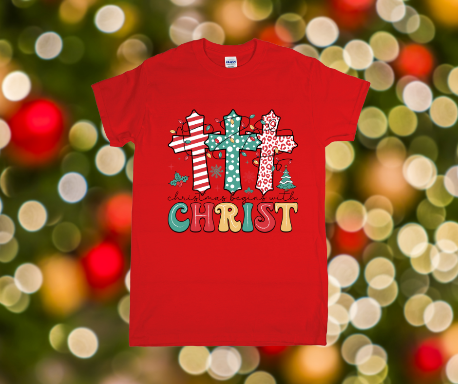 Red t-shirt with Christmas-themed design featuring crosses and 'Christ' text against a festive background.