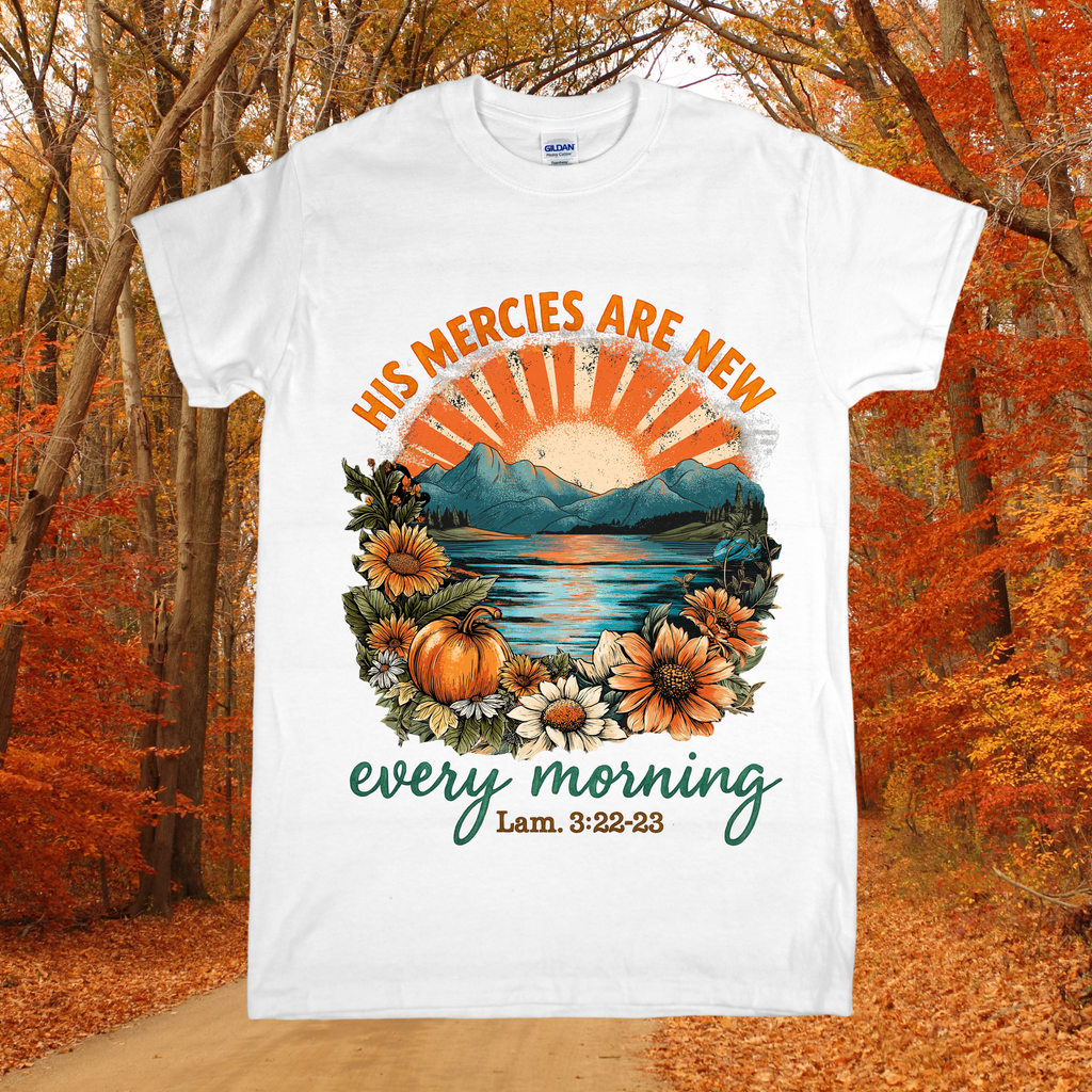 White t-shirt with autumn-themed design and text in a forest setting