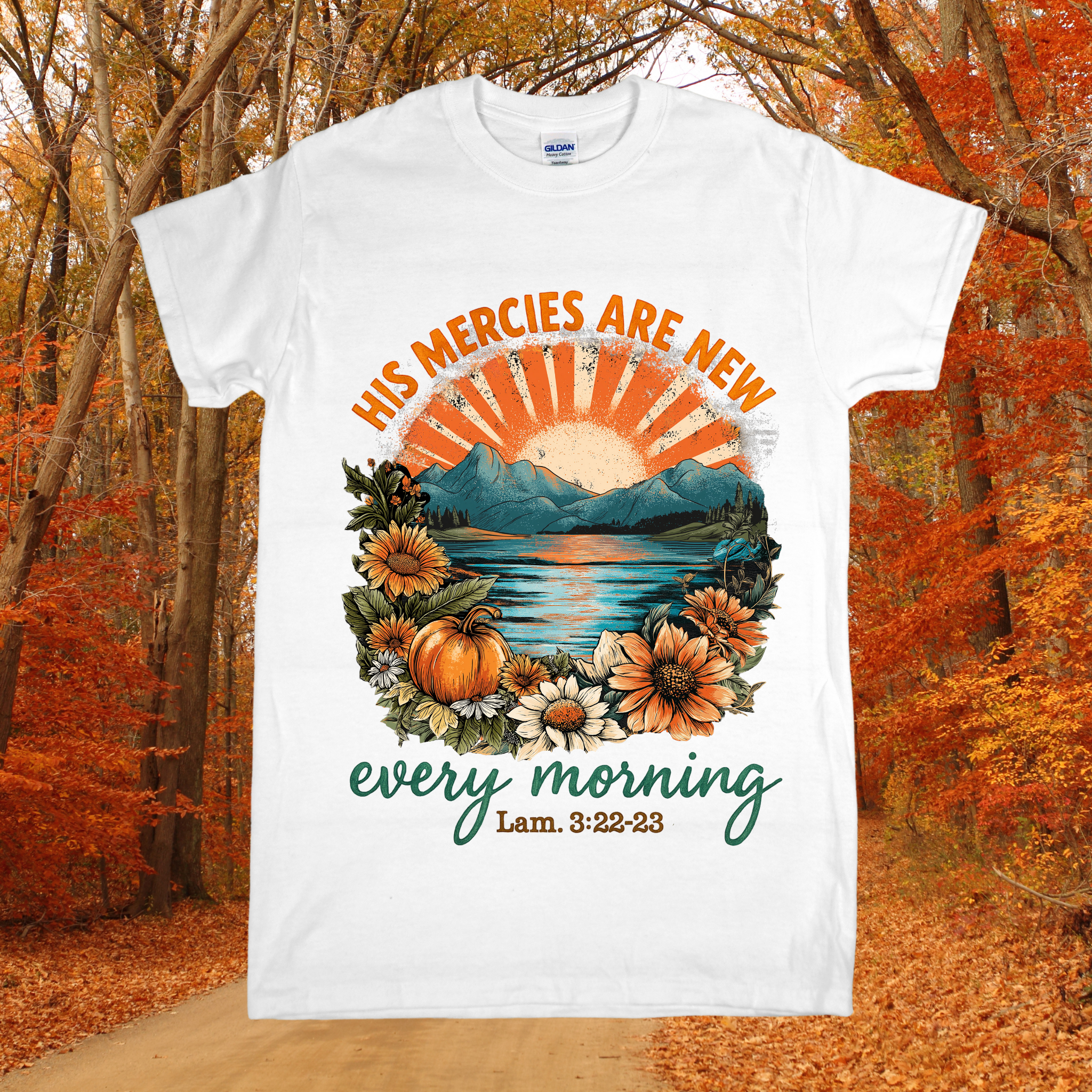 White t-shirt with autumn-themed design and text in a forest setting