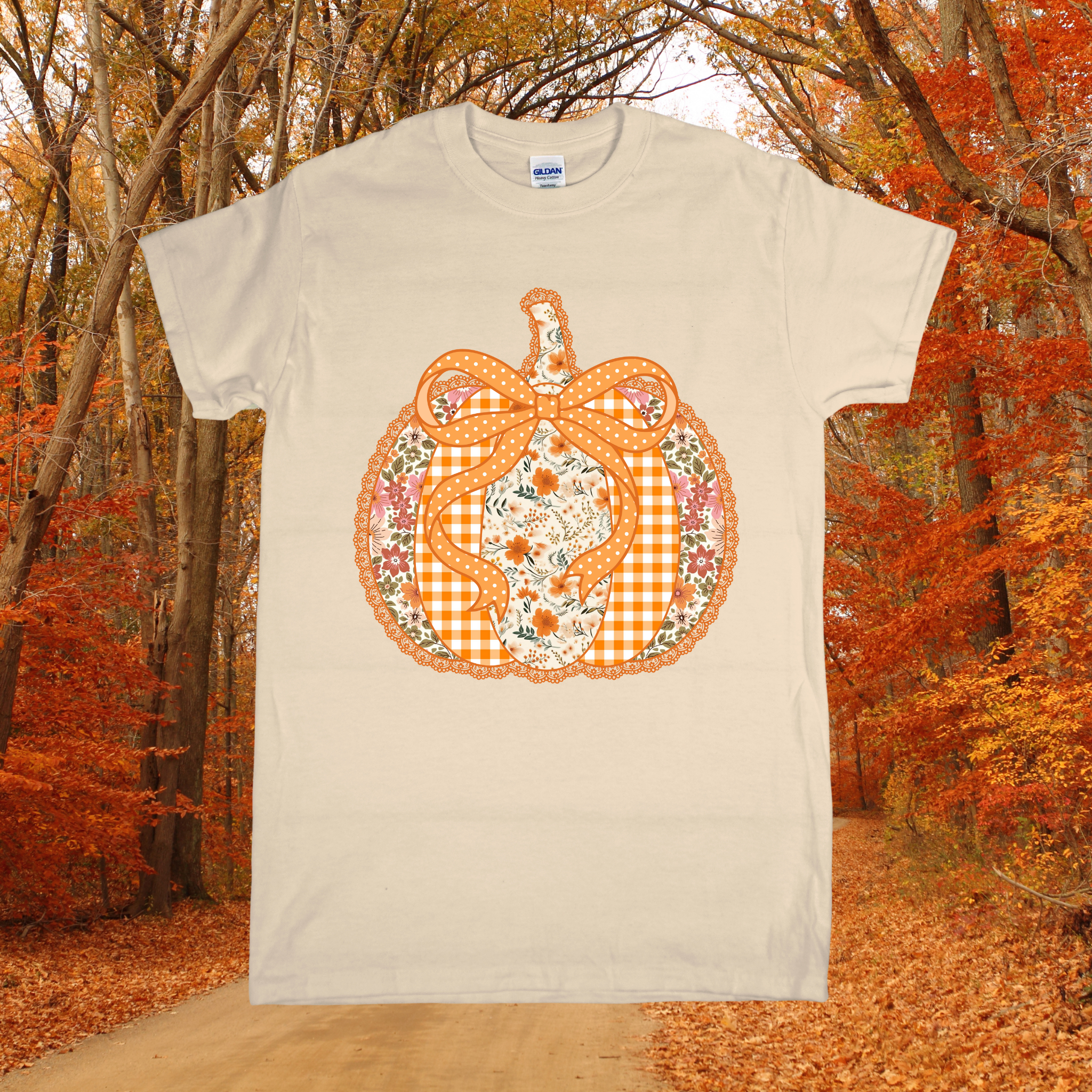 Beige t-shirt with a decorative pumpkin design in an autumn forest setting