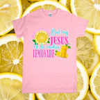 Pink t-shirt with colorful text and graphics on a background of lemon slices