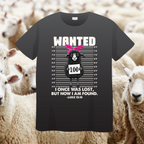 Black t-shirt with a graphic of a sheep and text, surrounded by sheep in a field.