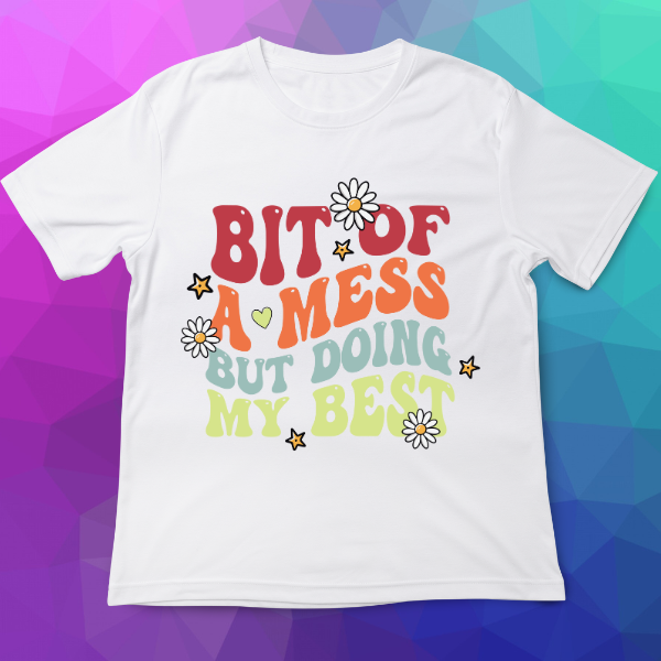 White t-shirt with colorful text and flowers on a multicolored geometric background