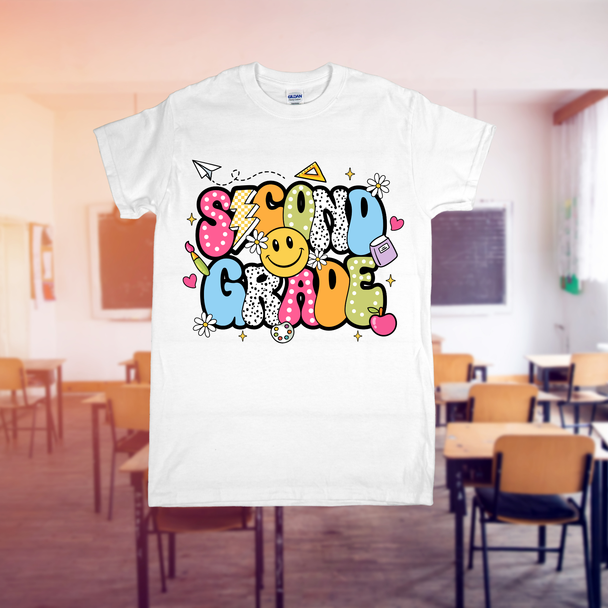 White t-shirt with 'SECOND GRADE' printed in colorful letters on a classroom background