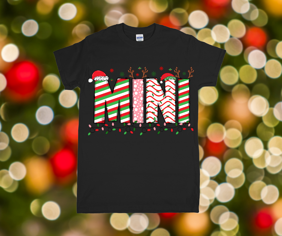 Black t-shirt with Christmas-themed design on a blurred festive background